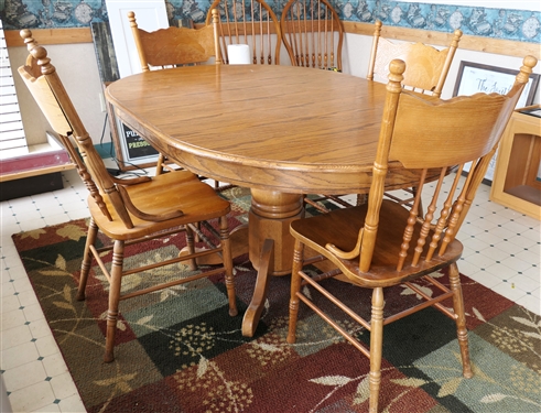 Oak Pedestal Base Dining Table and 4 Matching Chairs - Table Has 1 Leaf Can be Round or Oblong - Chair Have Scrolled Press Carved Backs - Table Measures 30" tall 60" by 41" Leaf Measures 18"
