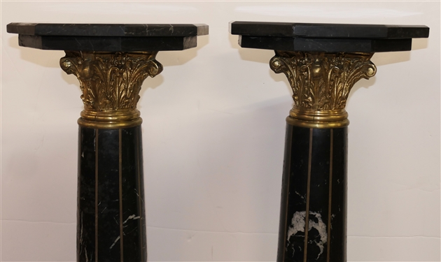 Pair of Outstanding Neoclassical Black Marble Corinthian Column Pedestals - Black Marble Top, Base, and Pedestal - Substantial Brass Corinthian Capitals - Pedestals Measure 46 Tall 13 Across