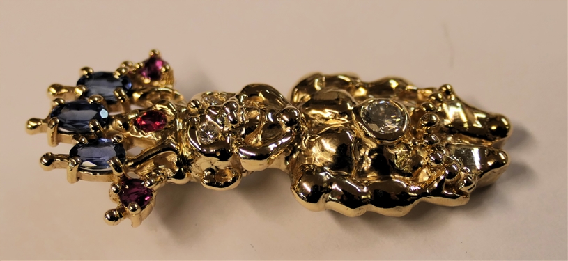 14kt Yellow Gold Tribal Figure Pendant - 1/4 Carat Round Diamond Set in Belly and Round Diamond Eyes, Sapphire and Rubies in Crown - Pendant Measures 1 5/8 Long - Weighs 10.5 Grams